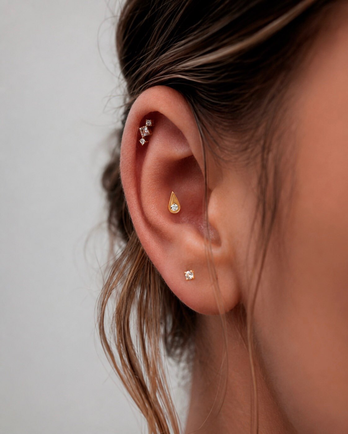 Helix piercing with gold jewelry in Barcelona - Circa Piercing